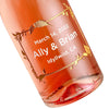 Etched wedding favors with a floral frame design and Rose wine by Etching Expressions