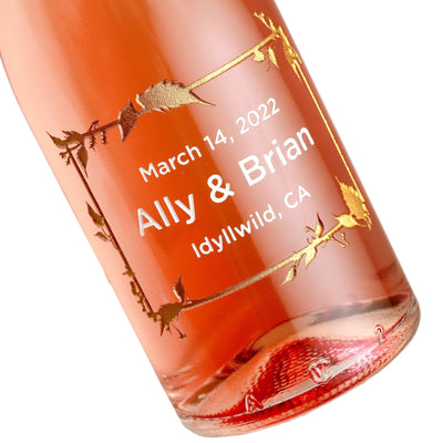 Etched wedding favors with a floral frame design and Rose wine by Etching Expressions