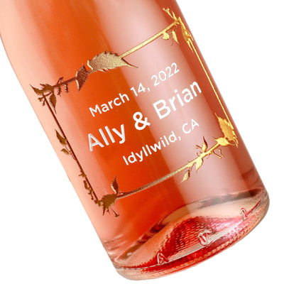 Case of etched mini rose wine wedding favors with floral frame design by Etching Expressions
